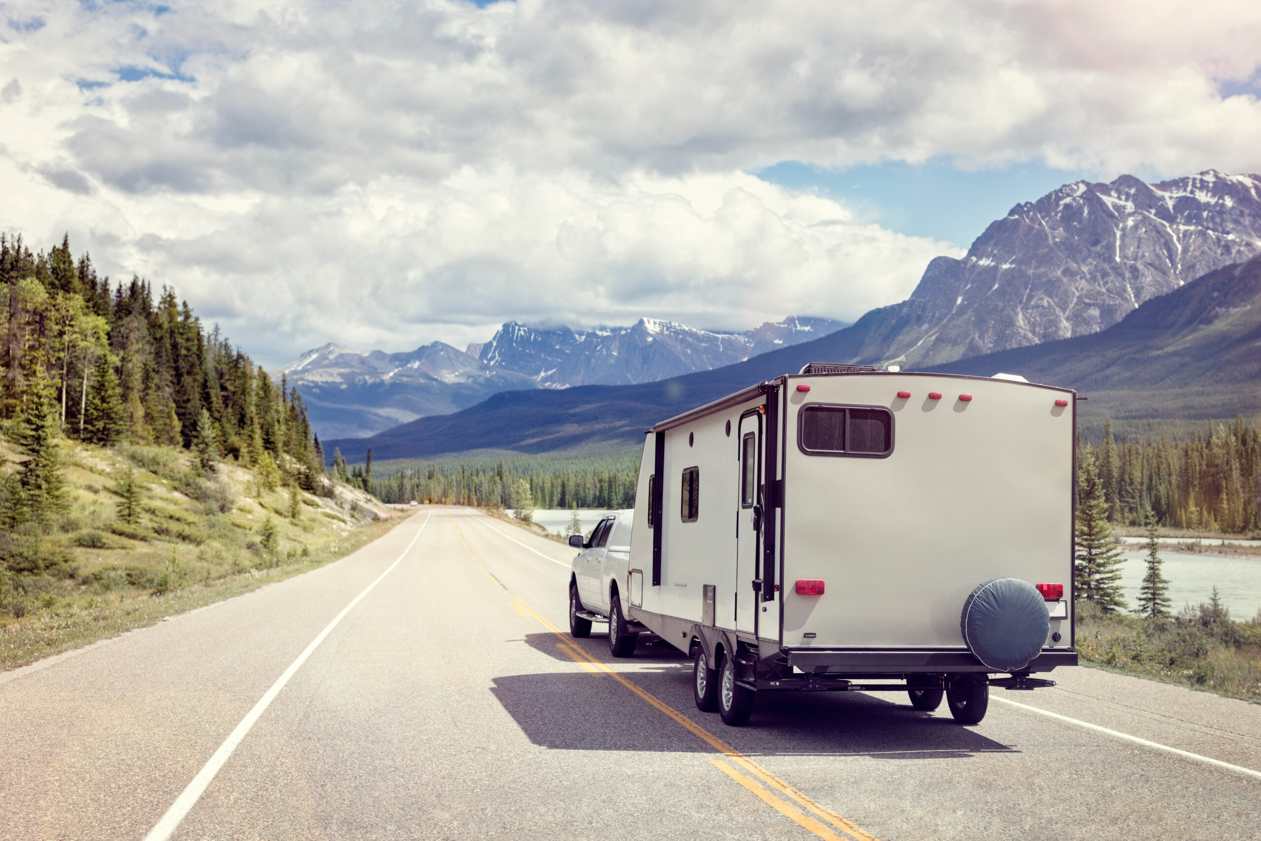 Caravan or recreational vehicle motor home trailer on a mountain road in Canada